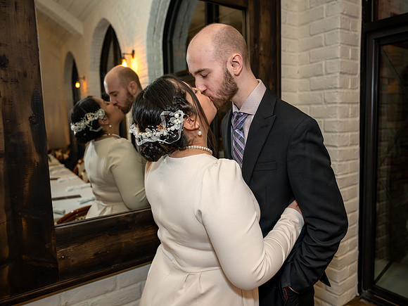 Bride and groom kiss at reception in Apple Valley, Minnesota