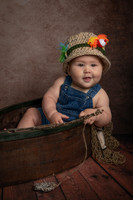 6 month portrait of a little boy in a wooden fishing boat - fishing theme portrait - Emily, MN