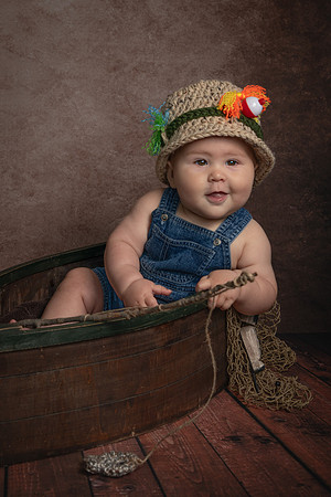 6 month portrait of a little boy in a wooden fishing boat - fishing theme portrait - Emily, MN