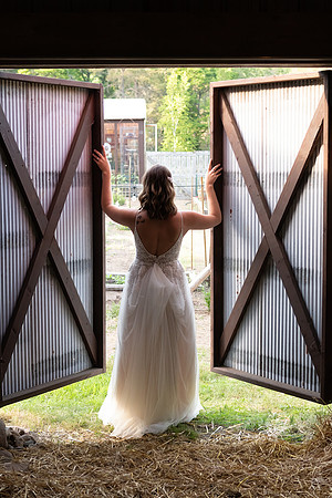 Bride opening the barn doors in Breezy Point, Minnesota