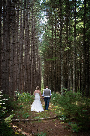 Bride and groom walk in a pine tree forest - Emily, Minnesota