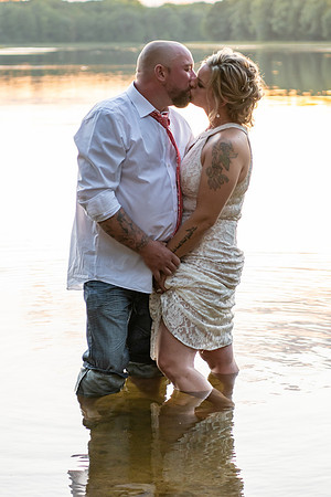 Bride and groom kissing in the lake at sunset in Emily, Minnesota - Minnie Lake