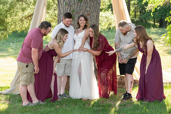 Bridal party admiring the wedding ring in Breezy Point, Minnesota