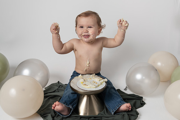 1 year old boy enjoying his birthday cake - Cake Smash in Emily Minnesota