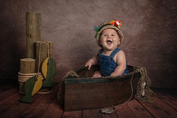 6 month portrait of a little boy in a wooden fishing boat - fishing theme portrait - Emily, MN